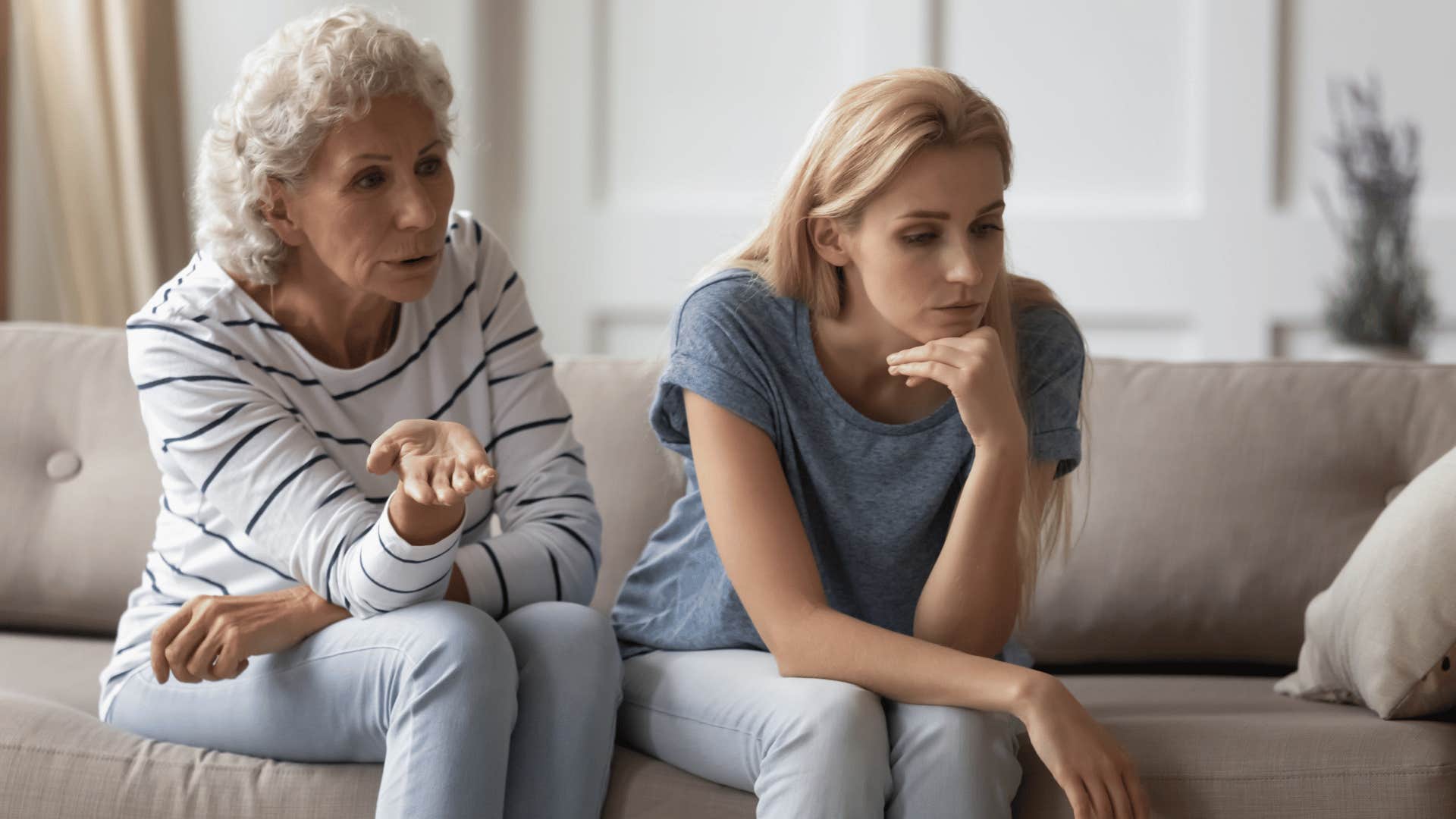 Grandmother being passive-aggressive with her grown daughter on her couch