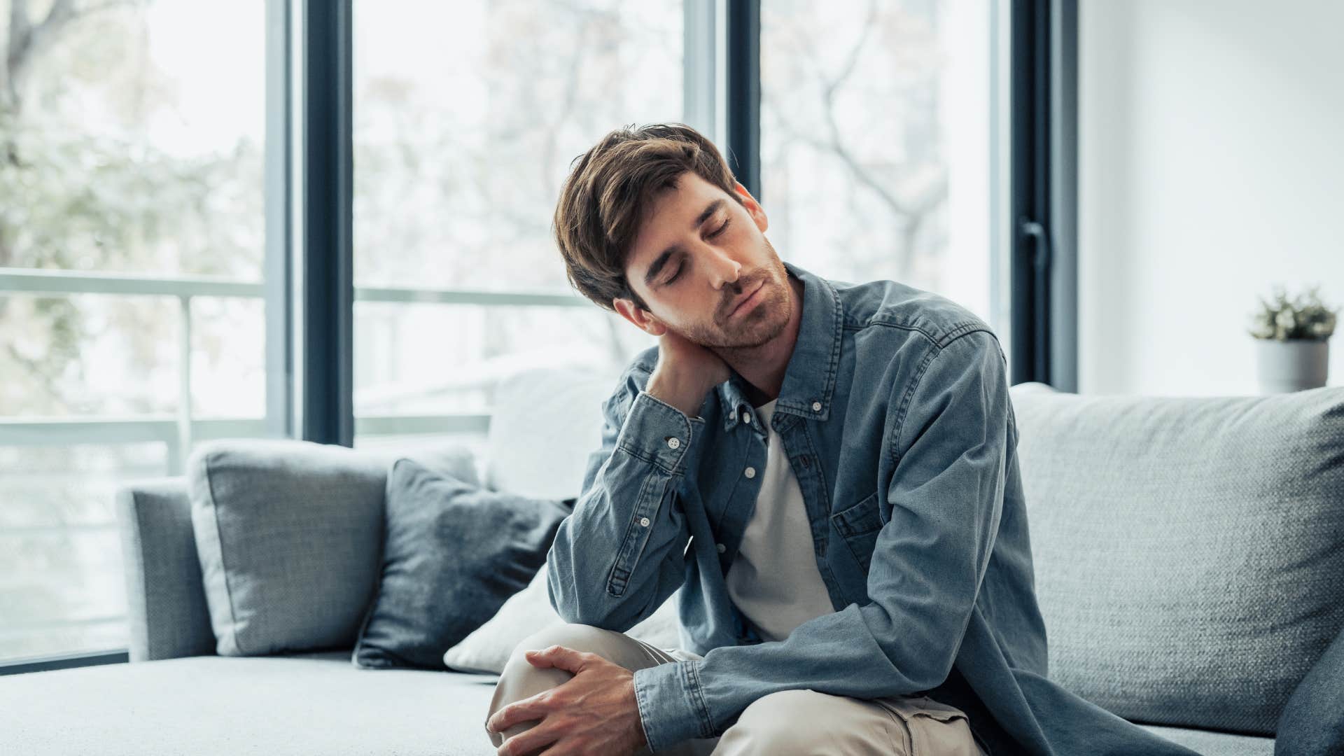 man feeling stressed sitting at home