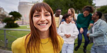 To Increase Your Likability, Do 10 Straightforward Things, Says Psychologist likable young red-haired girl with wide smile and piercing look