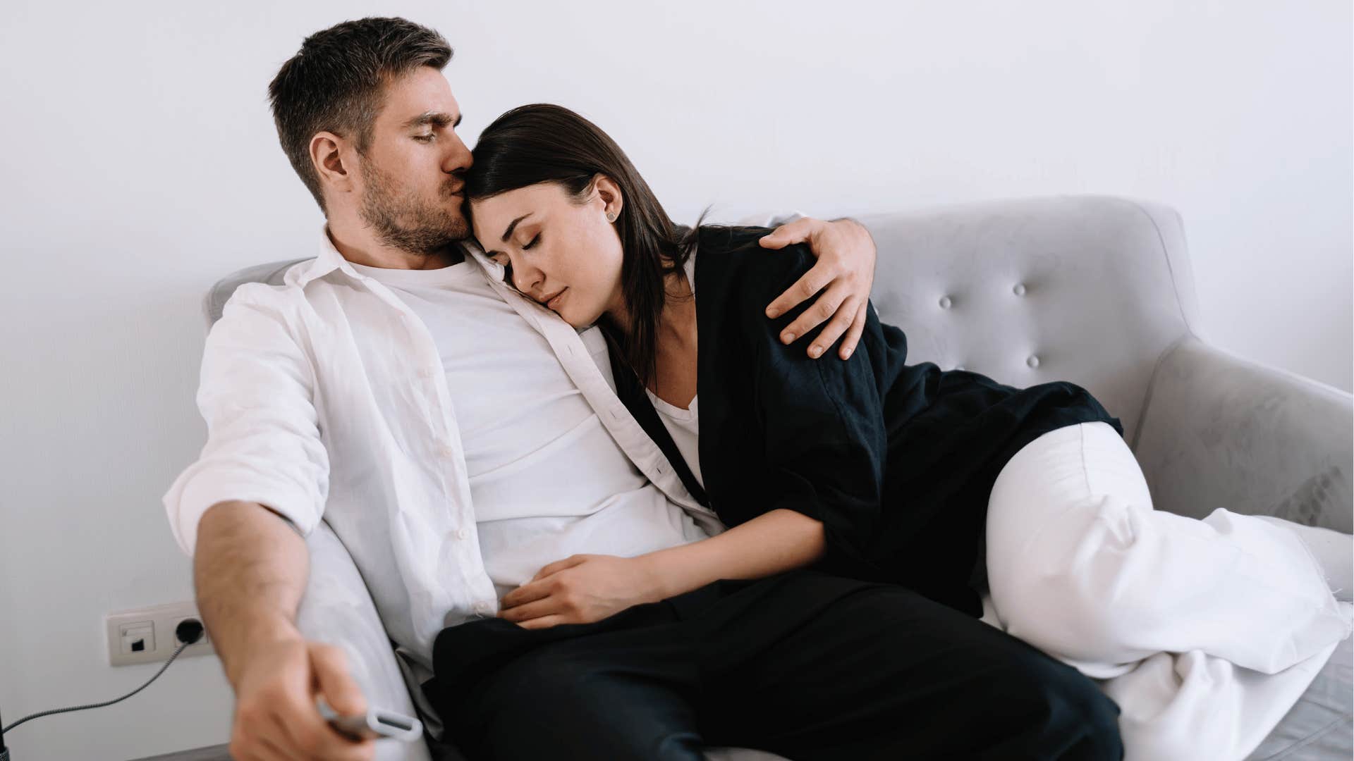 couple snuggling on the couch worried about being perfect