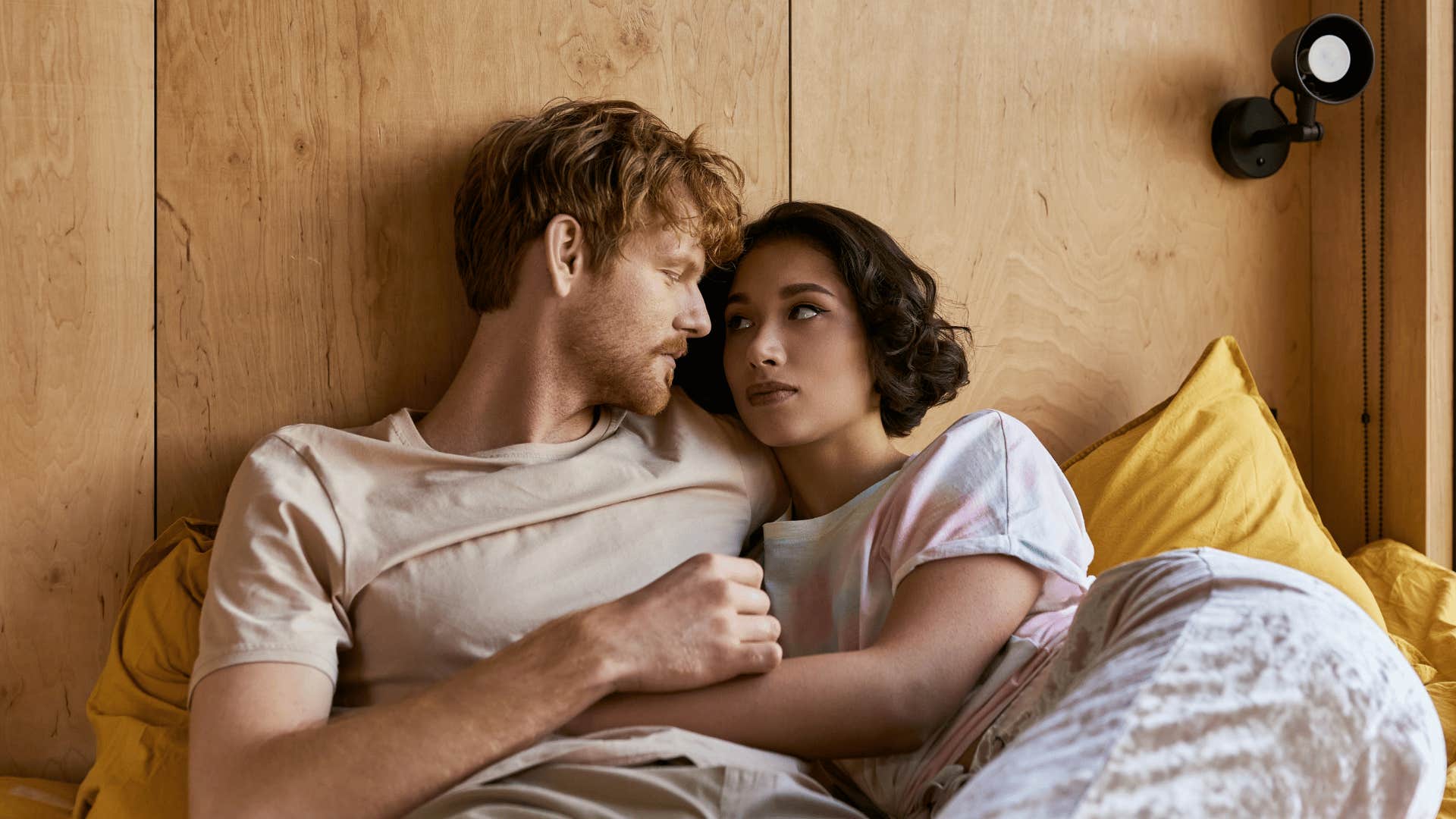 couple in bed sharing secrets together