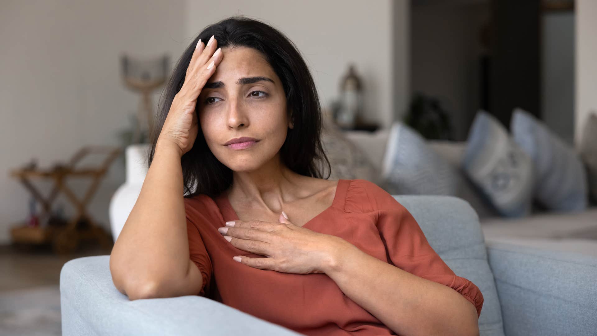 distraught woman struggling to ask for reassurance sitting alone
