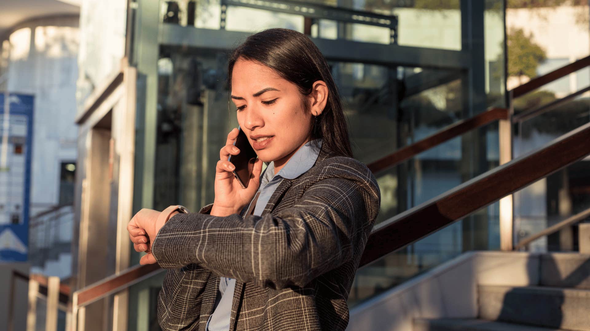 woman looking at her watch running late and making a bad first impression