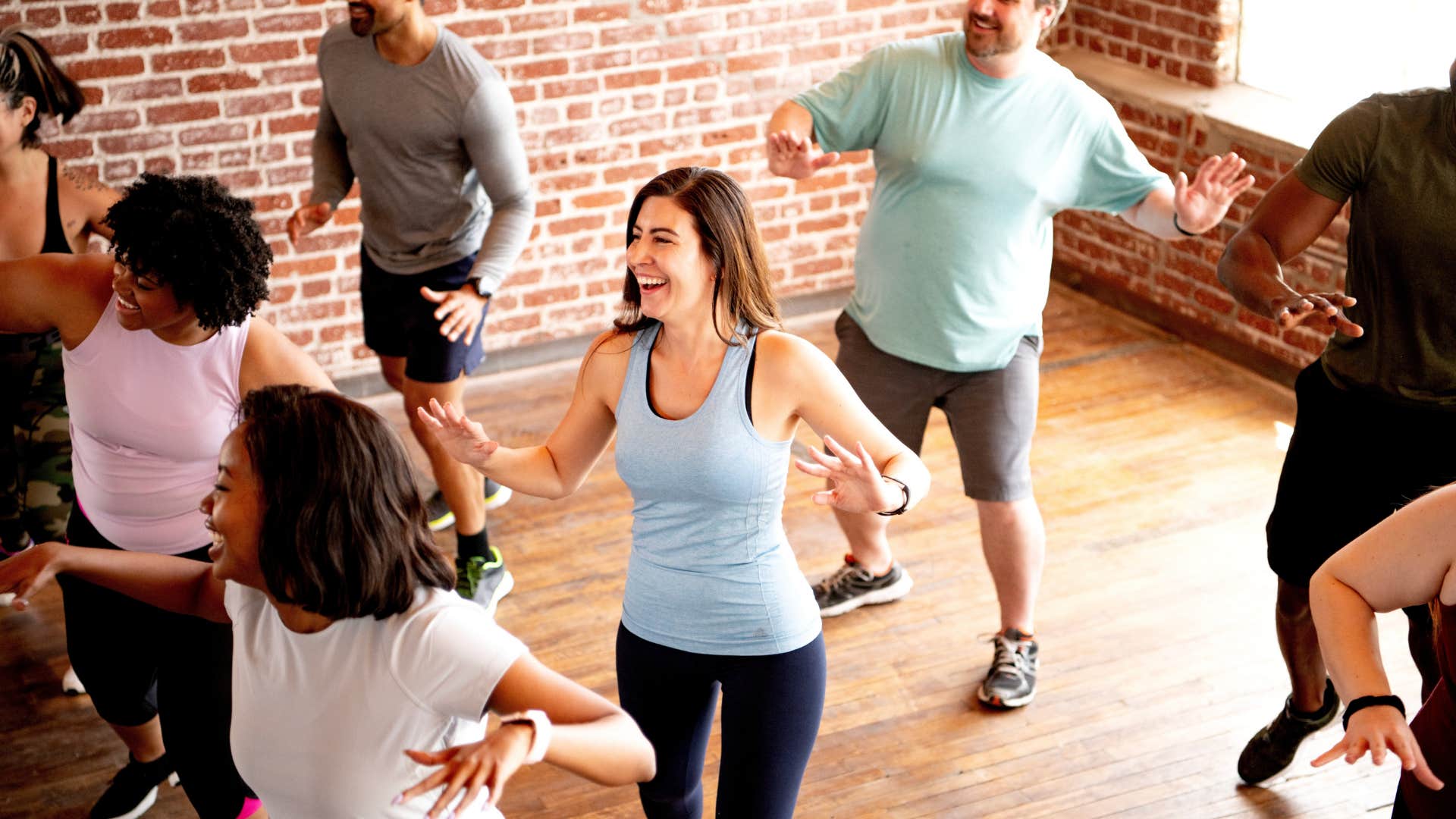 Excited person exercises in group showing they might be obsessed