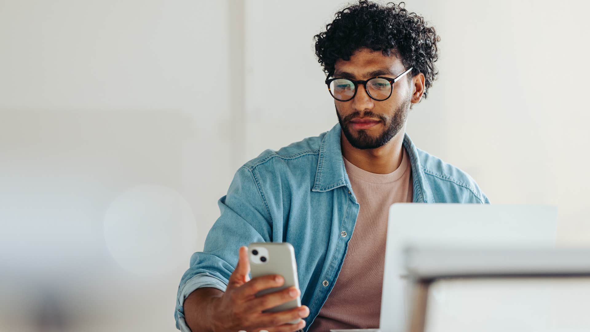 Distracted person receives text message showing they might be obsessed