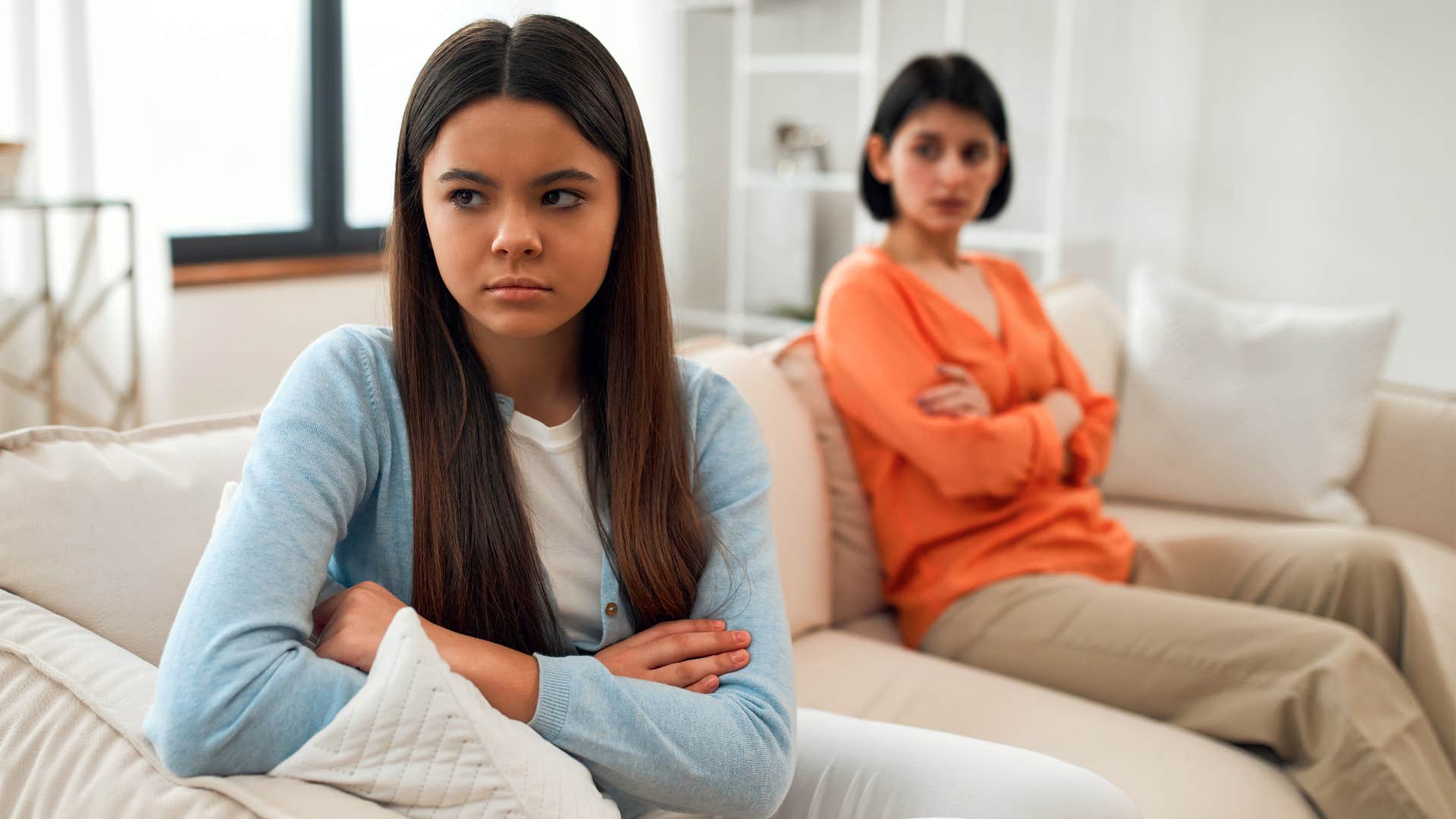 Teenage Gen Z daughter annoyed and turned away from her upset mom