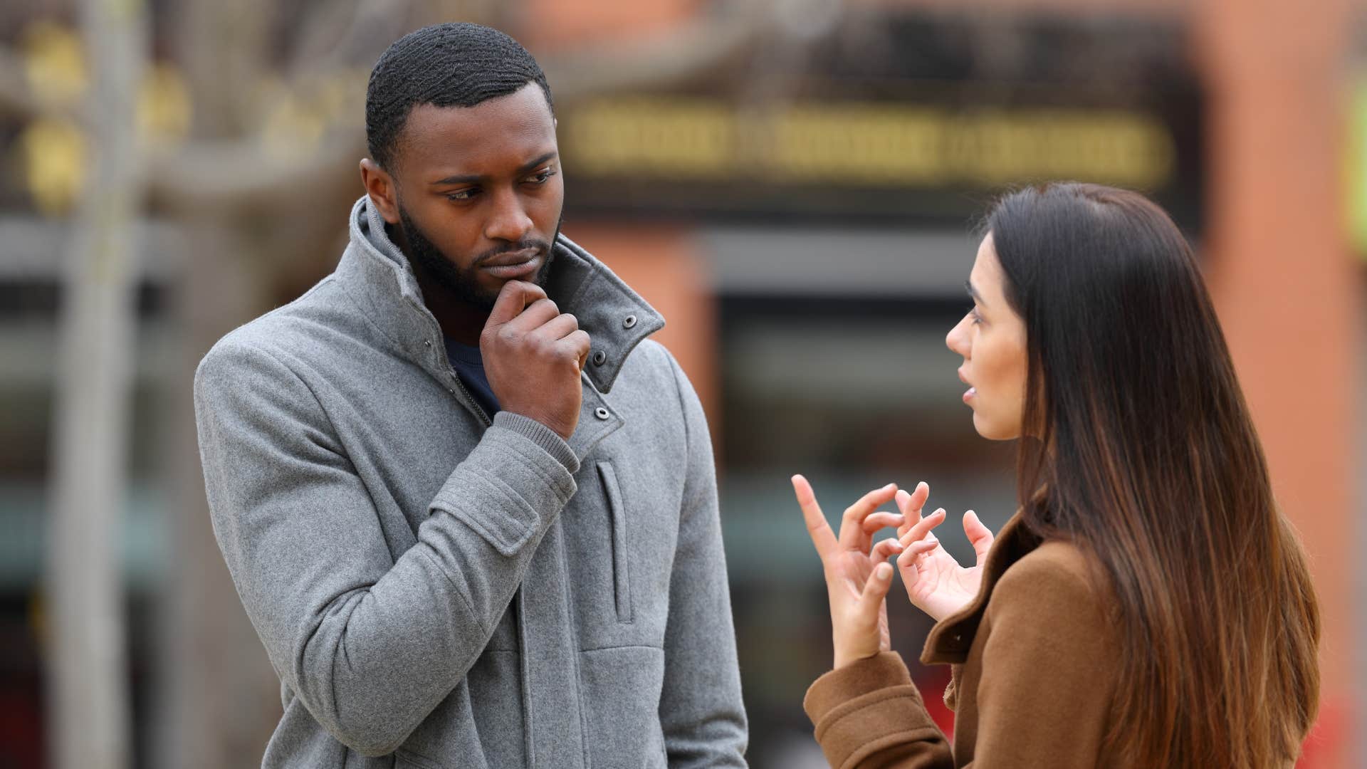 man thinking deeply as woman in brown jacket asks what stood out most to you