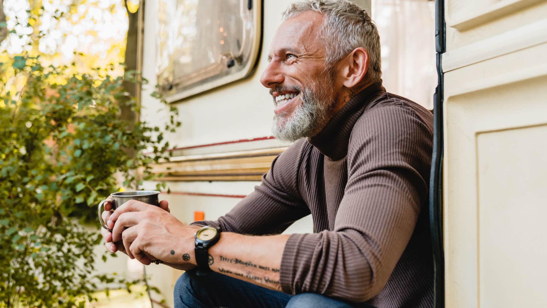 man maximizing his alone time at home drinking coffee