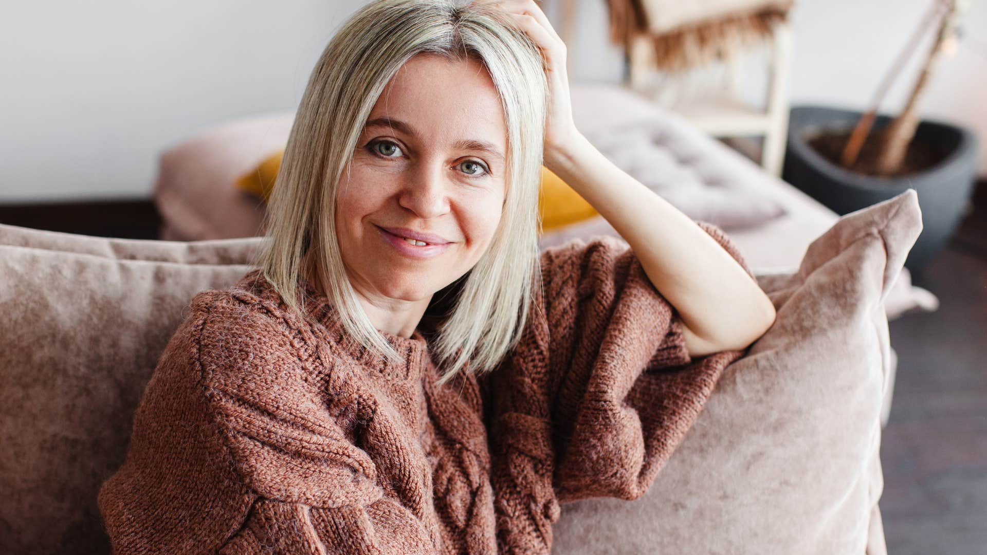 woman who values alone time sitting on her couch