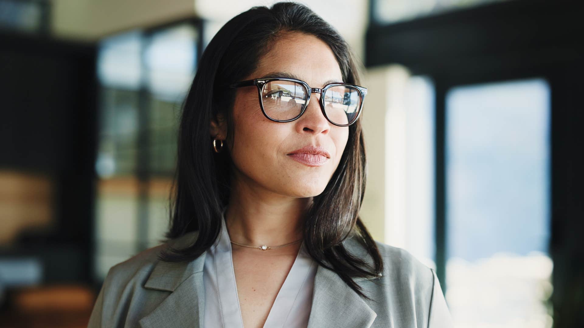 woman wearing glasses thinking about insightful questions