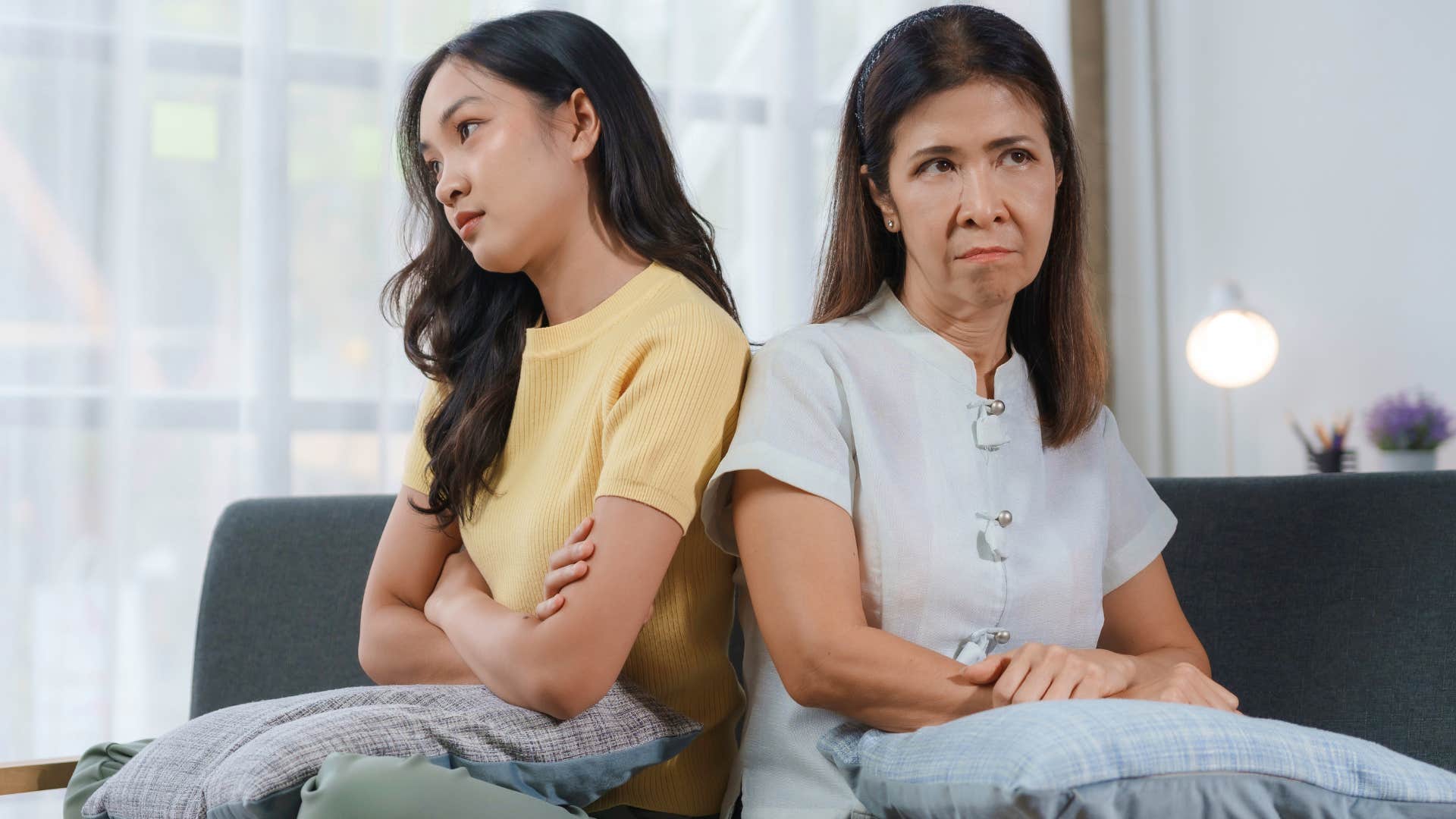 Toxic mother refuses to talk to her adult daughter with backs toward each other