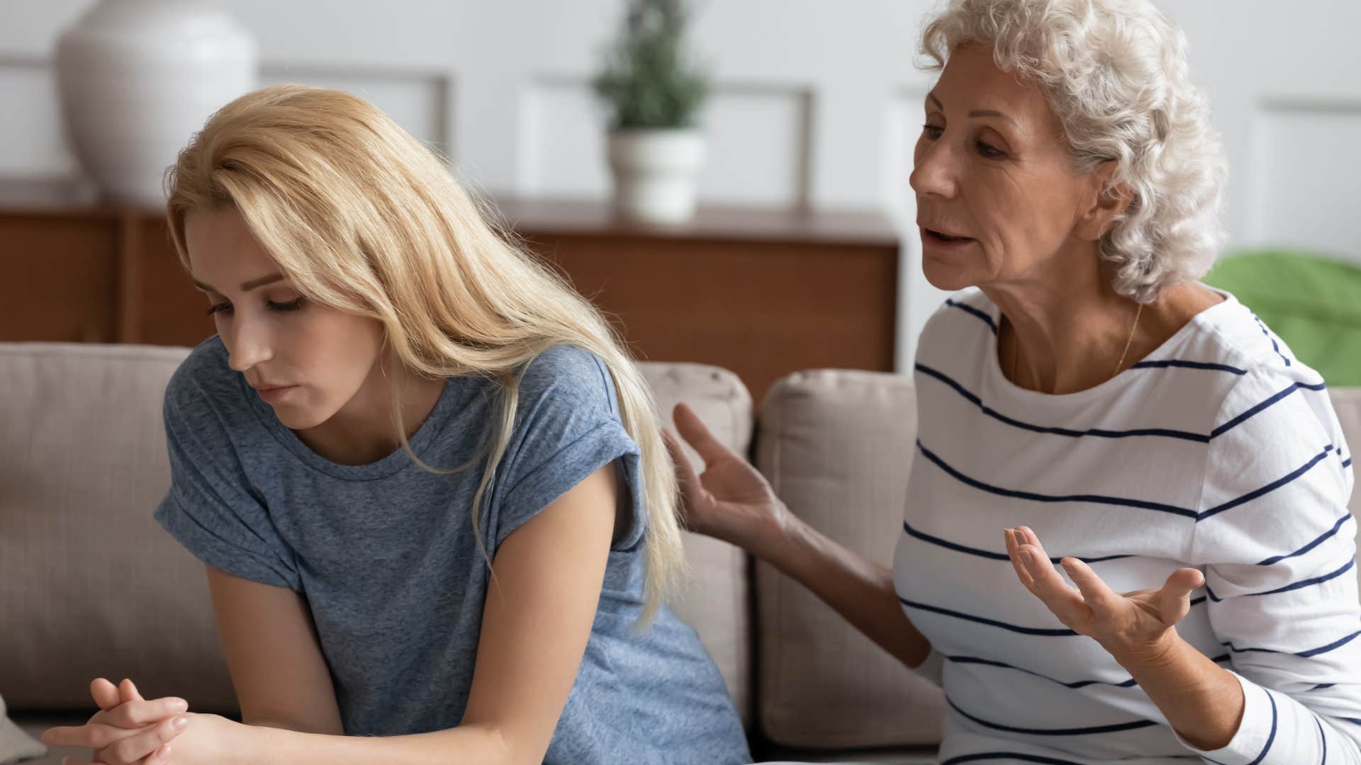 Young woman turned away from her toxic mom arguing with her at home