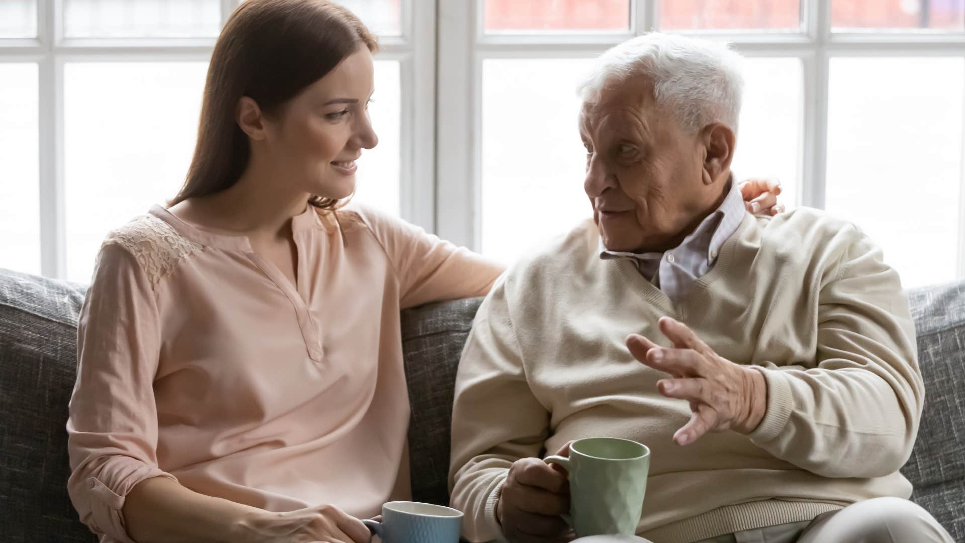 Adult daughter listening intently to her older father 