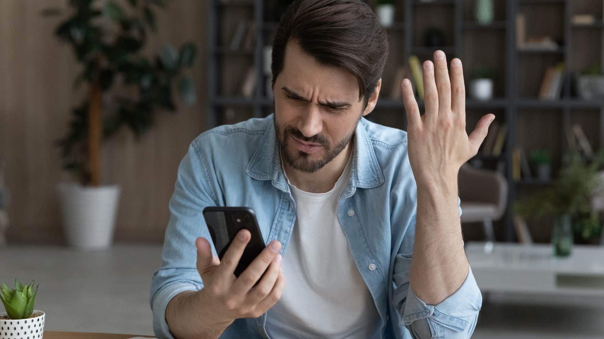 Man looking annoyed at his phone