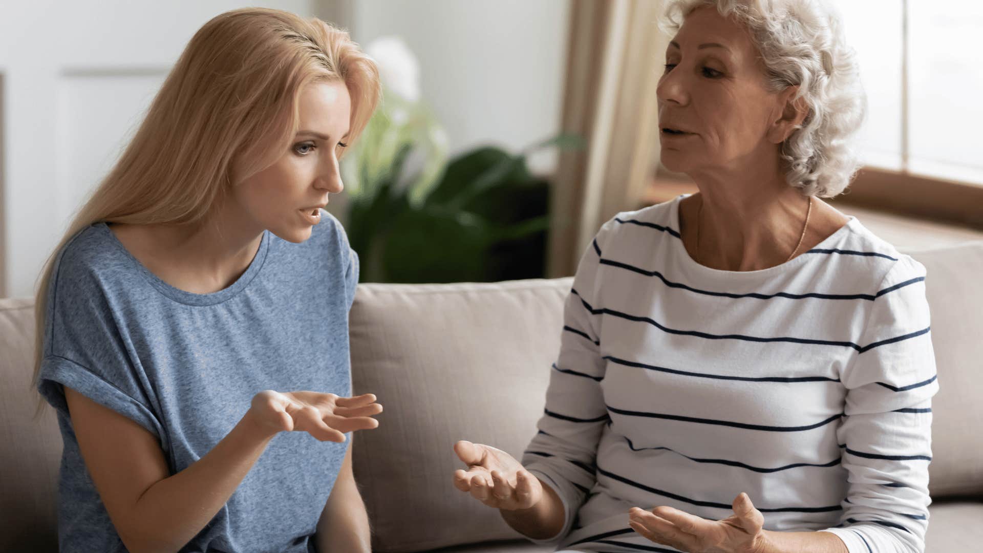 Grown up daughter looks frustrated talking to her older mother 