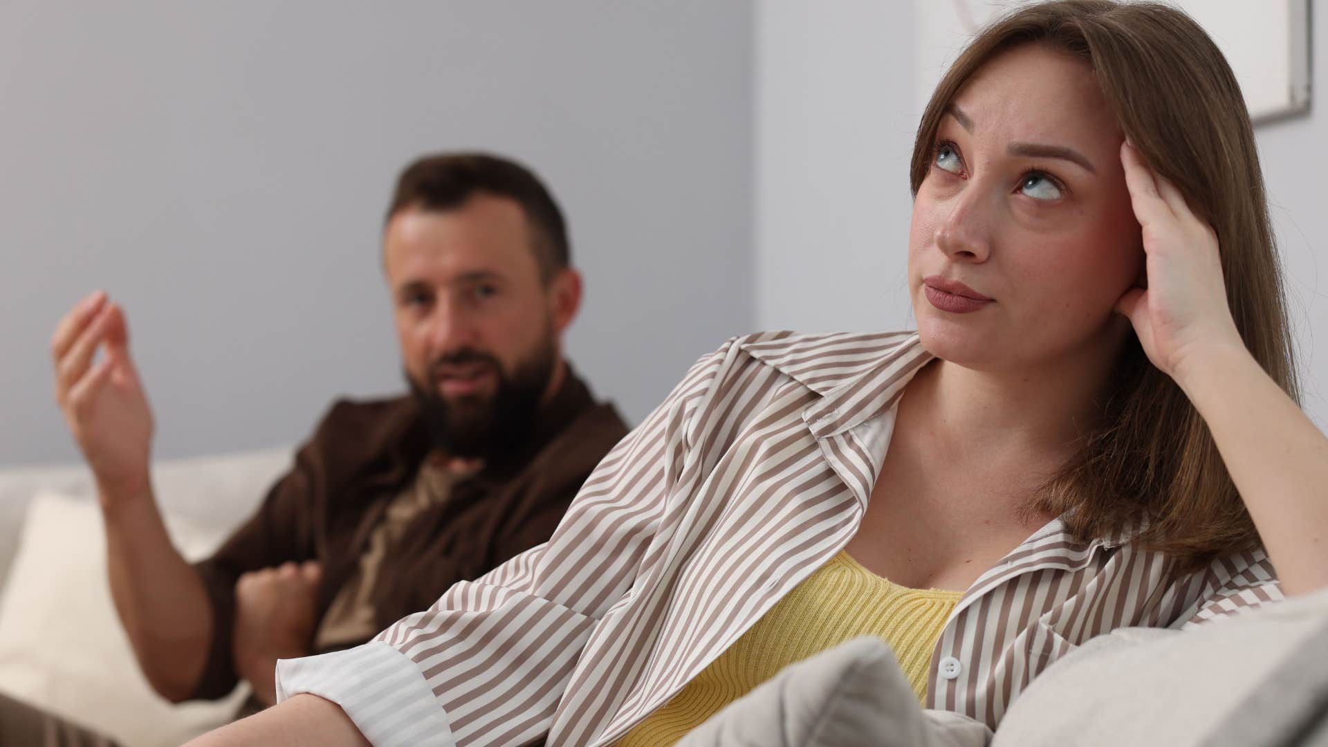 passive aggressive woman rolling her eyes saying must be nice to her husband