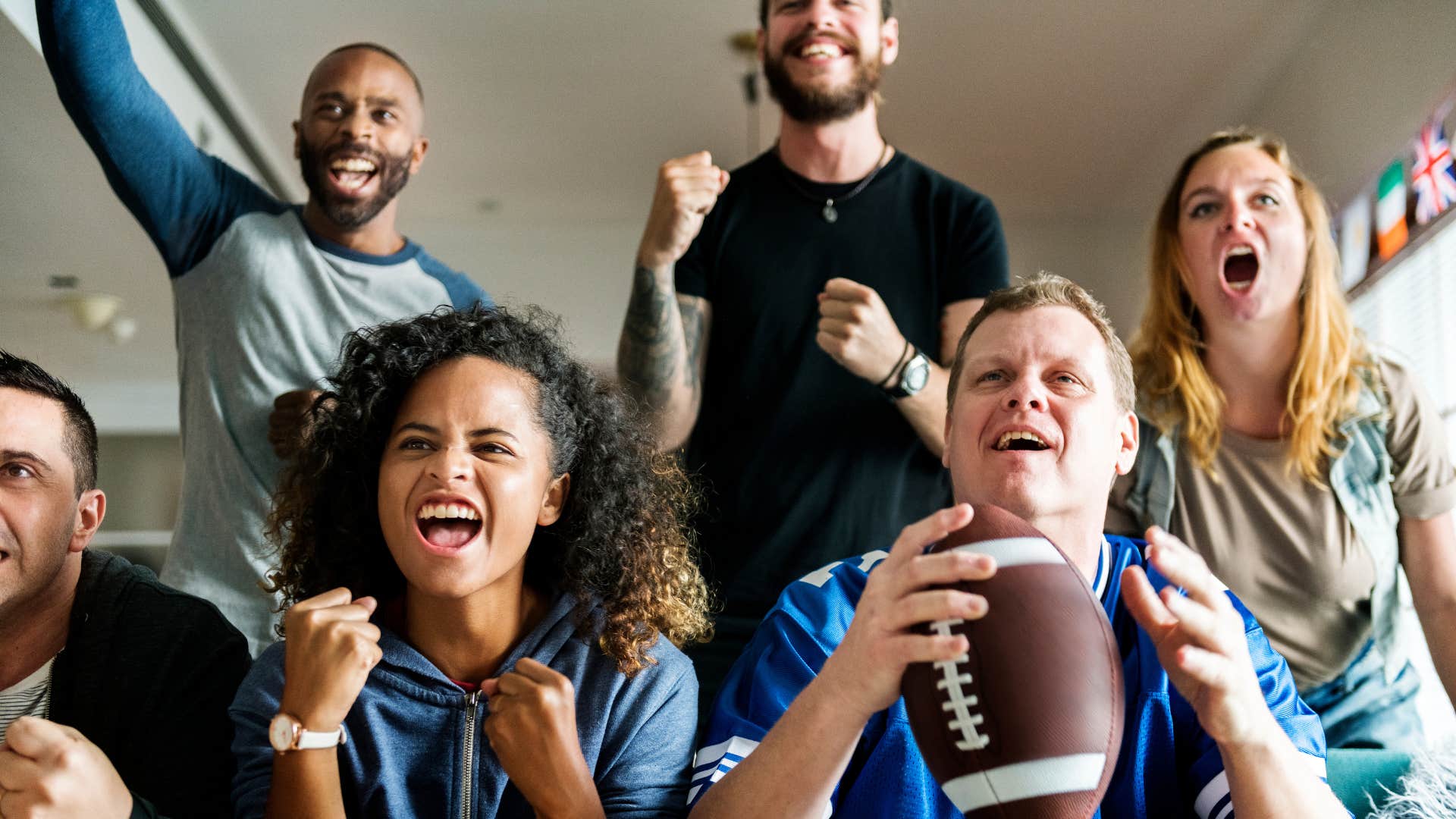 Happy friends watch football showing post-divorce fun
