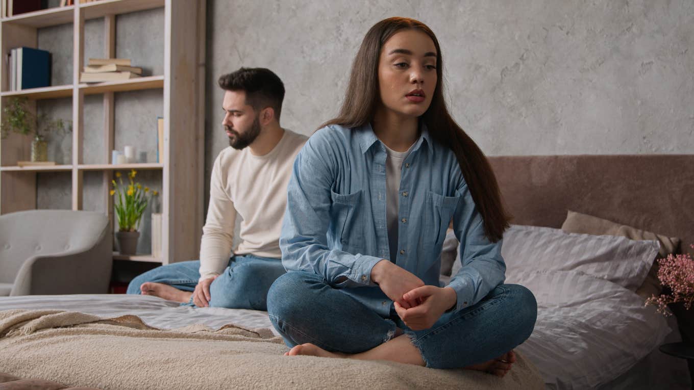sad woman sitting with back to her partner