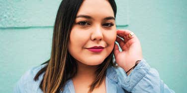If You’re Tired Of Saying Yes To Everything, Psychologist Says These Boundary Habits Actually Stick A confident young plus-size woman looking directly at the camera with a calm and resolute expression, illustrating the 'self-possession' required to maintain firm personal boundaries.