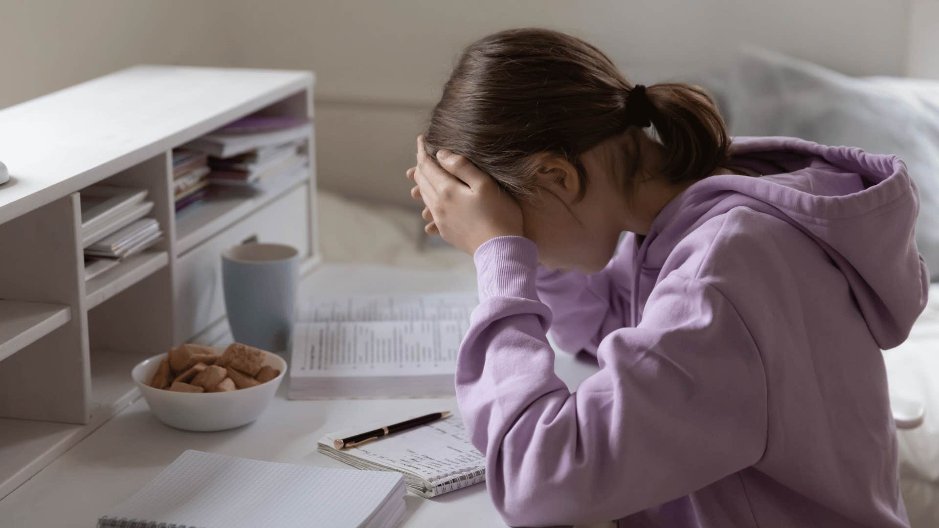 Gen Z teen frustrated at her desk by her parents unintentional traits