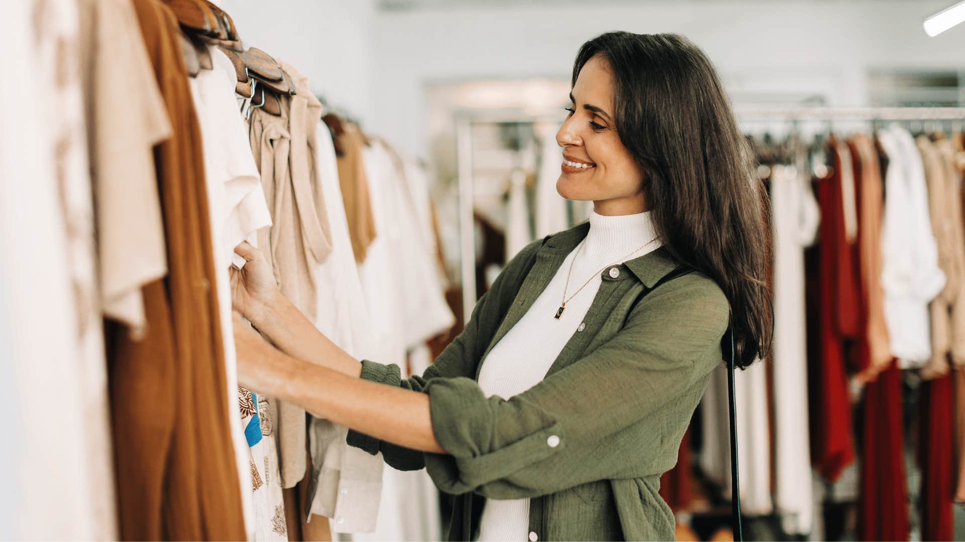 Woman who grew up with lots of money looking at expensive clothes
