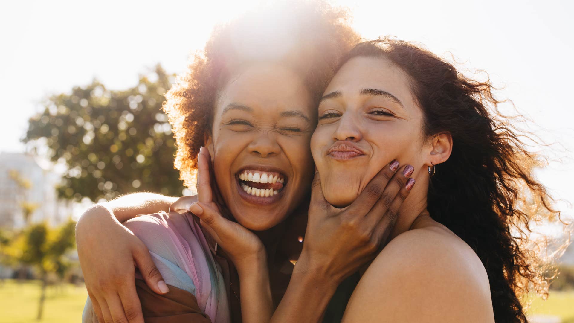 loyal friends smiling and hugging outside