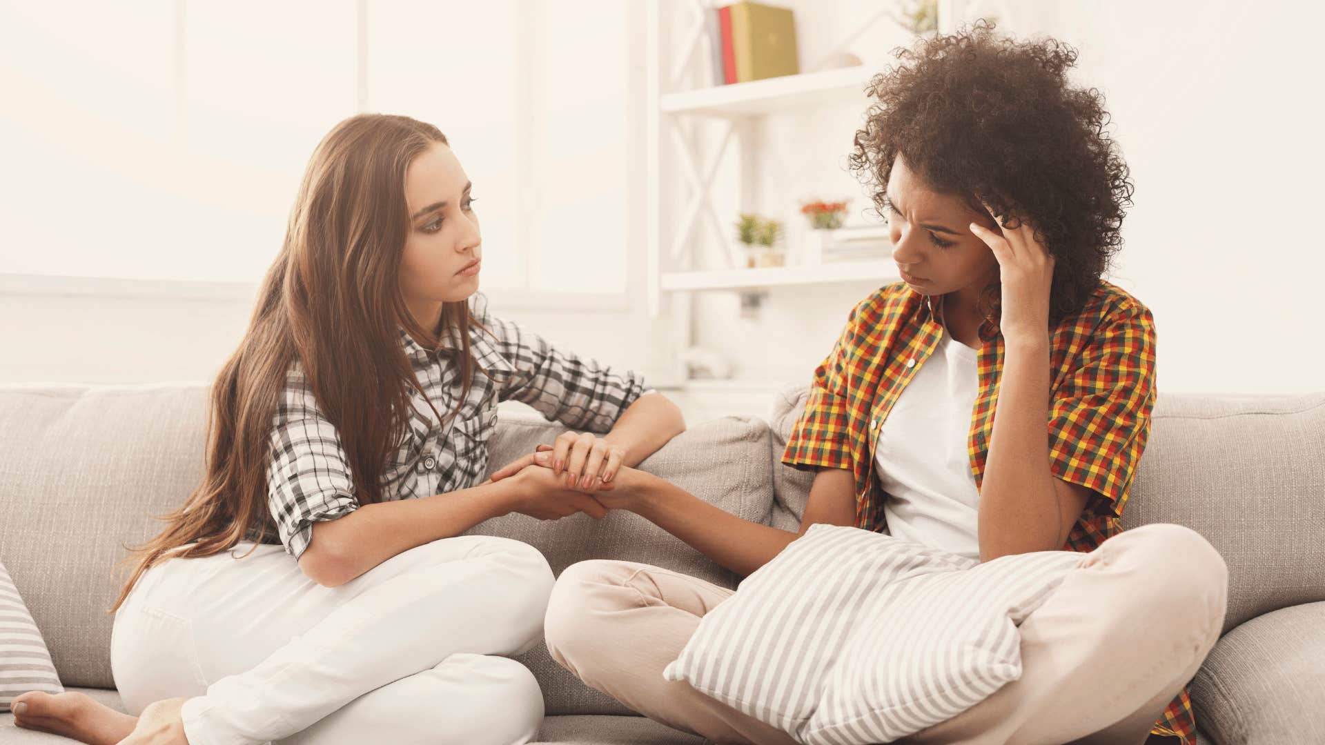 Young woman whose parents did an exceptional job gives support to a sad friend